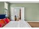 Peaceful bedroom featuring neutral wall color, wood furniture and a view into the Primary bath with dual sinks at 6886 Sundrop St, Harmony, FL 34773