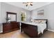 Bedroom with a queen bed, dark wooden dresser, and a tranquil, cozy ambiance at 6886 Sundrop St, Harmony, FL 34773