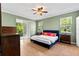 Bright bedroom featuring a king bed, natural light and access to the outdoors at 6886 Sundrop St, Harmony, FL 34773