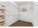 Walk-in closet with ample shelving and storage space for organized living at 6886 Sundrop St, Harmony, FL 34773