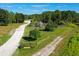 Aerial view of the community garden with its lovely gazebo, winding pathways, trees and greenery at 6886 Sundrop St, Harmony, FL 34773