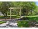 Tranquil community park featuring a pergola over a pathway, surrounded by mature trees and lush green space at 6886 Sundrop St, Harmony, FL 34773