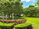 Well-maintained community green space featuring manicured landscaping, mature trees, and inviting benches at 6886 Sundrop St, Harmony, FL 34773