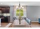 Well-lit dining room with a rustic wooden table and modern chandelier at 6886 Sundrop St, Harmony, FL 34773
