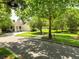 Beautiful home exterior with a manicured lawn and mature trees, showcasing the well-maintained facade and neighborhood charm at 6886 Sundrop St, Harmony, FL 34773
