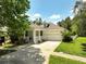 Charming home featuring a well-manicured lawn and a welcoming front porch, complete with an attached two-car garage at 6886 Sundrop St, Harmony, FL 34773