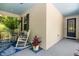 Inviting front porch with rocking chairs, blue rug, and colorful plants at 6886 Sundrop St, Harmony, FL 34773