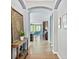 Inviting hallway with archway leading to an open living space and stylish decor at 6886 Sundrop St, Harmony, FL 34773