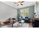 Comfortable living room featuring neutral walls, a ceiling fan, and stylish furniture at 6886 Sundrop St, Harmony, FL 34773