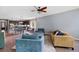 Cozy living room showcasing tile flooring, neutral walls, and an open layout with seamless transition to the dining area at 6886 Sundrop St, Harmony, FL 34773