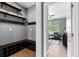 Mudroom with built-in bench, storage cubbies, shelves and coat hooks for organized entry at 6886 Sundrop St, Harmony, FL 34773