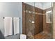 Updated shower with glass enclosure, brown tiling with decorative inset, and modern fixtures at 6886 Sundrop St, Harmony, FL 34773