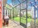 Screened-in outdoor space featuring lush greenery and a well-maintained lawn at 715 Honeysuckle Ave, Celebration, FL 34747