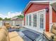 Relax on this balcony with comfortable seating and french doors to the interior at 715 Honeysuckle Ave, Celebration, FL 34747