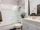 This bathroom includes a glass-enclosed shower, white vanity, and modern fixtures at 715 Honeysuckle Ave, Celebration, FL 34747