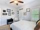 This bedroom features a ceiling fan, stylish decor, and a door with plantation shutters at 715 Honeysuckle Ave, Celebration, FL 34747