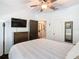 Bedroom featuring a ceiling fan, natural light, comfortable bed with stylish decor, TV and an ensuite bathroom at 715 Honeysuckle Ave, Celebration, FL 34747