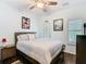 Bright bedroom featuring a ceiling fan, natural light, and a comfortable bed with stylish decor at 715 Honeysuckle Ave, Celebration, FL 34747