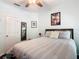 Light bedroom featuring a ceiling fan, natural light, comfortable bed with stylish linens and dark hardwood floors at 715 Honeysuckle Ave, Celebration, FL 34747