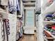 Well-organized walk-in closet with custom shelving and bench seat under the window at 715 Honeysuckle Ave, Celebration, FL 34747