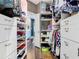 Spacious walk-in closet with custom shelving and storage leading to en suite bath at 715 Honeysuckle Ave, Celebration, FL 34747