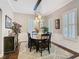 Stylish dining room with modern lighting, wainscoting, and a cozy rug, perfect for entertaining at 715 Honeysuckle Ave, Celebration, FL 34747