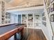 Bright game room features high ceilings, a loft area, and a pool table with shelving to the side at 715 Honeysuckle Ave, Celebration, FL 34747