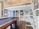 The loft space over looks a large game room with hardwood floors, a pool table, and loft access stairs at 715 Honeysuckle Ave, Celebration, FL 34747