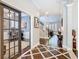 Open hallway with decorative flooring, leading to a bright office and staircase at 715 Honeysuckle Ave, Celebration, FL 34747