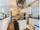 Open kitchen features black countertops, white cabinets, bar seating, and pendant lighting at 715 Honeysuckle Ave, Celebration, FL 34747
