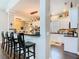 Open kitchen with black countertops, white cabinets, bar seating, and stainless steel appliances at 715 Honeysuckle Ave, Celebration, FL 34747
