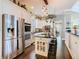 Bright kitchen boasts stainless steel appliances, granite counters, modern pendant lighting and tiled floors at 715 Honeysuckle Ave, Celebration, FL 34747
