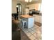 Bright kitchen with a central island, white cabinets, and modern appliances at 715 Honeysuckle Ave, Celebration, FL 34747