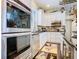 Kitchen features stainless steel appliances, white cabinets, black countertops, brick backsplash and decor at 715 Honeysuckle Ave, Celebration, FL 34747