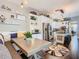 Kitchen with stainless appliances and dining area with decorative shelves and bench seating at 715 Honeysuckle Ave, Celebration, FL 34747