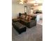 Inviting living room featuring a comfortable sofa and ottoman with a view into the kitchen at 715 Honeysuckle Ave, Celebration, FL 34747