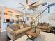 Bright living room with a soaring ceiling, hardwood floors, and an open concept to the kitchen at 715 Honeysuckle Ave, Celebration, FL 34747
