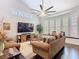 Comfortable living room with large TV, shutters, vaulted ceiling and cozy seating at 715 Honeysuckle Ave, Celebration, FL 34747