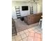 Spacious living room with a couch, ottoman and decoratively accessorized with standing shelf ladders at 715 Honeysuckle Ave, Celebration, FL 34747