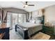 This main bedroom has access to a private balcony, stylish furniture, and great natural light at 715 Honeysuckle Ave, Celebration, FL 34747