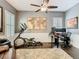 Bright office space featuring a ceiling fan, exercise equipment, and a large, decorative area rug at 715 Honeysuckle Ave, Celebration, FL 34747