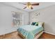 Cozy bedroom with ceiling fan, a large window, and carpet at 7830 Myrtle Oak Ln, Kissimmee, FL 34747
