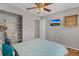 Bedroom with ceiling fan, a large window, television, and open closet at 7830 Myrtle Oak Ln, Kissimmee, FL 34747