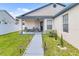Cozy front porch with seating, decorative plants, and manicured landscaping at 7830 Myrtle Oak Ln, Kissimmee, FL 34747