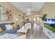 Open-concept living room with wood floors, stylish decor, and an abundance of natural light at 7830 Myrtle Oak Ln, Kissimmee, FL 34747
