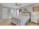 Spacious bedroom with a ceiling fan, ensuite bathroom, and large windows for ample natural light at 7830 Myrtle Oak Ln, Kissimmee, FL 34747