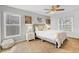 Bright bedroom with a ceiling fan, soft carpet, and large windows for ample natural light at 7830 Myrtle Oak Ln, Kissimmee, FL 34747