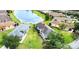 An aerial view showcases this home's prime location near a serene lake and lush green surroundings at 817 Grand Canal Dr, Kissimmee, FL 34759