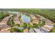Beautiful aerial view of a residential community surrounding a serene lake and lush green spaces at 817 Grand Canal Dr, Kissimmee, FL 34759