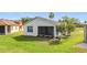 Lush backyard showcasing a screened-in patio and well-maintained lawn at 817 Grand Canal Dr, Kissimmee, FL 34759